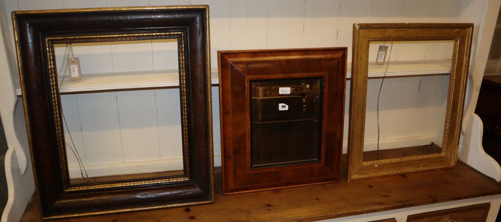 A walnut and parcel-gilt picture frame, a giltwood and gesso picture frame and a laburnum oyster veneered cushion frame, 45 x 50cm